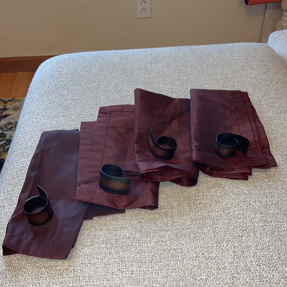 Four napkins and napkin rings
